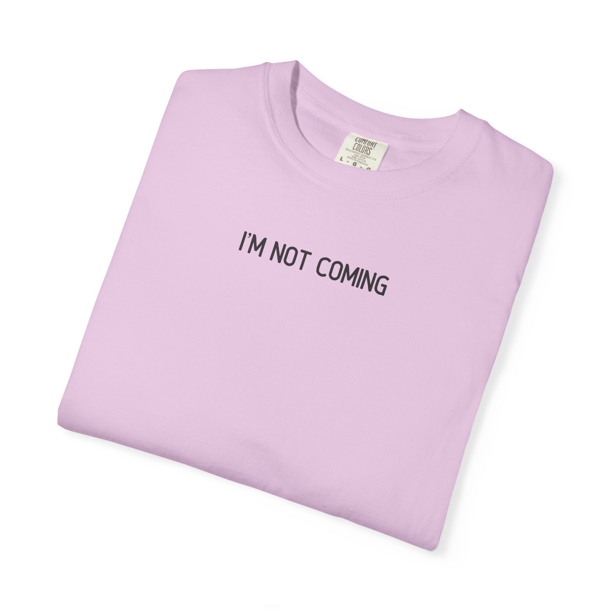 Folded light purple t-shirt with 'I'M NOT COMING' text on a white background